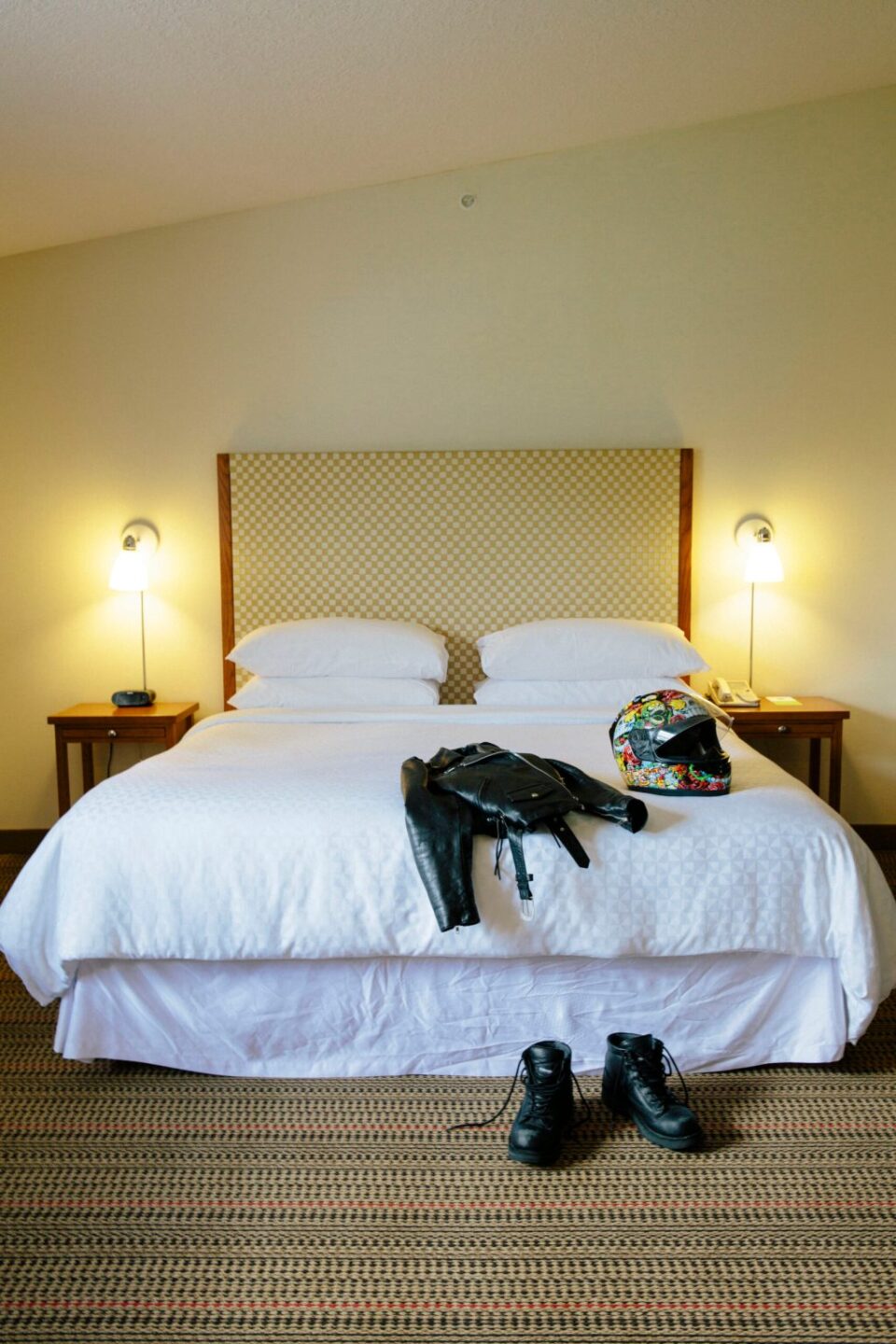 Motorcycle gear on bed in hotel room in Prince George along Route 16