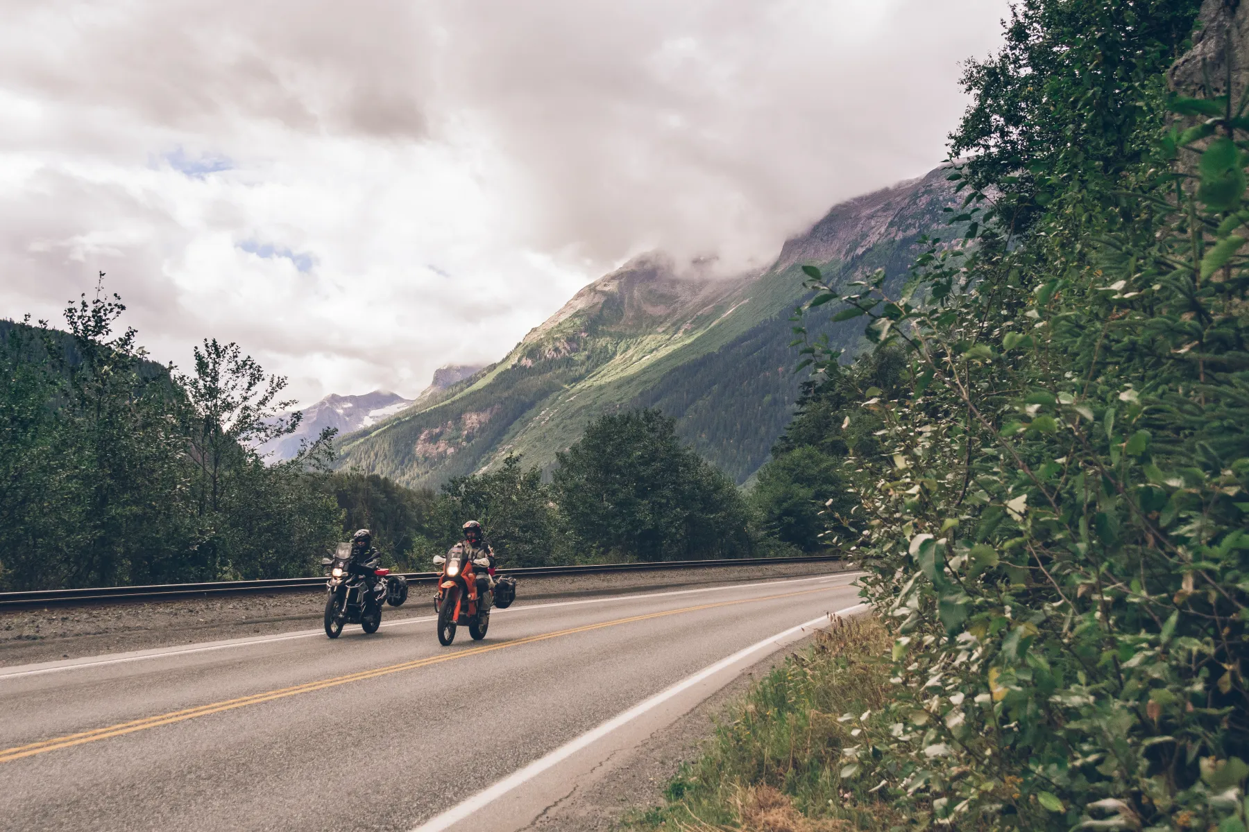 motorcycle riders on route 16 from terrace to prince rupert riding by carwash rock