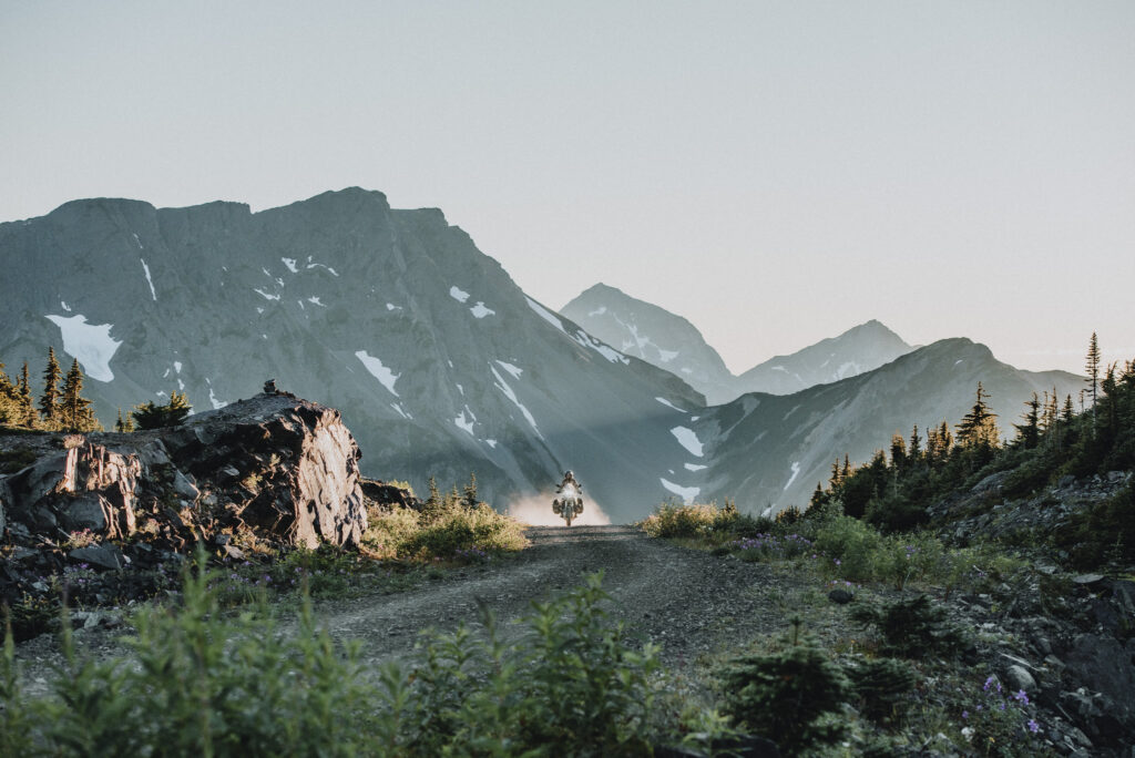 golnoosh namazi, a motorcyclist riding in front of mountains on adventure rides near terrace bc on route 16